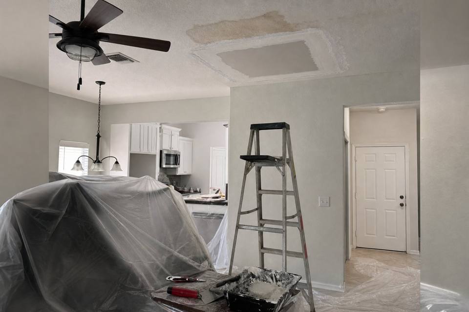 Ceiling drywall repair setup below a water stain in Vero Beach